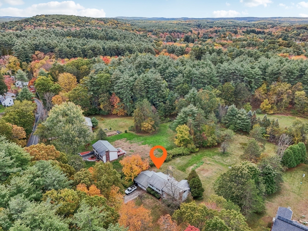 128 Harvard Road Stow, MA 01775 - Photo 3 of 36 an aerial view of a forest with houses