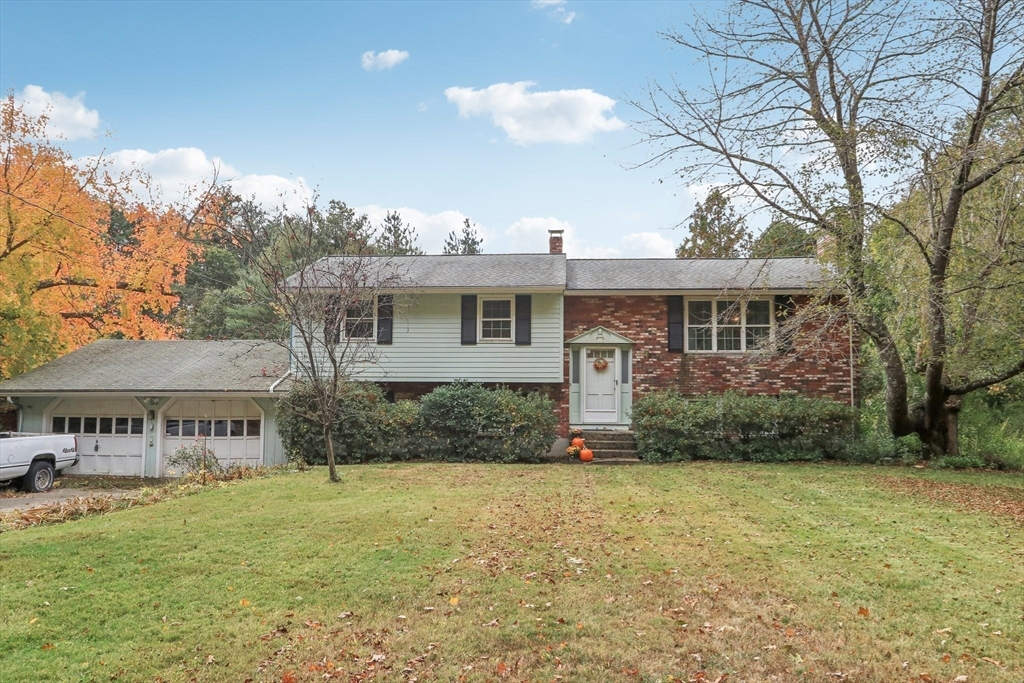 128 Harvard Road Stow, MA 01775 - Photo 31 of 36 a front view of a house with garden