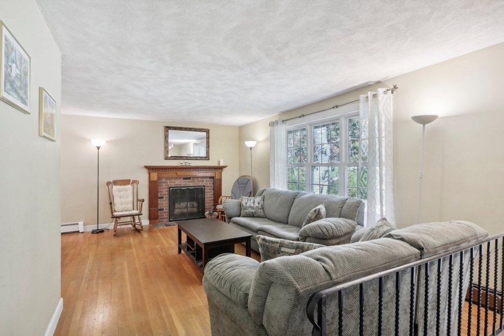 128 Harvard Road Stow, MA 01775 - Photo 6 of 36 a living room with furniture and a fireplace