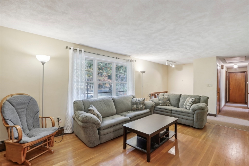 128 Harvard Road Stow, MA 01775 - Photo 7 of 36 a living room with furniture and a large window