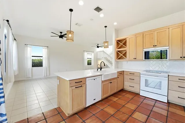 a kitchen with a sink stove and cabinets