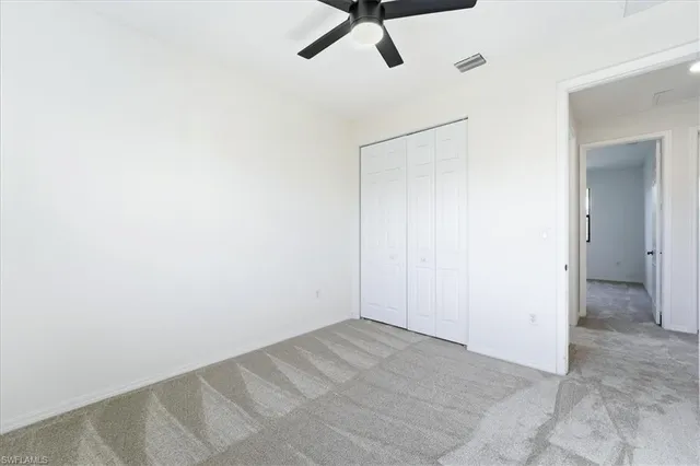 a view of a room with a ceiling fan