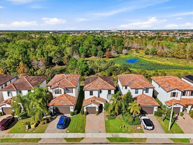 an aerial view of multiple houses with yard