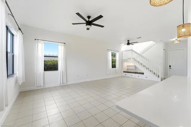 a view of a livingroom with a ceiling fan and window