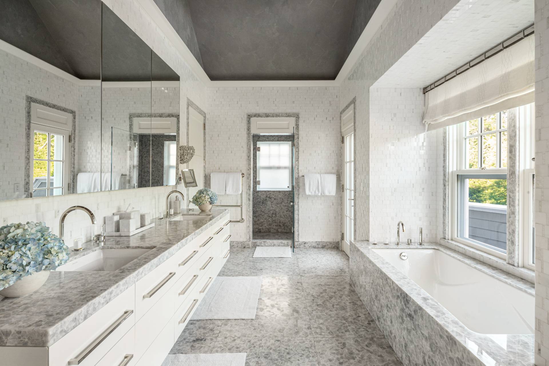 8 Hither Lane East Hampton, NY 11937 - Photo 19 of 38 a large bathroom with a granite countertop tub and a large window