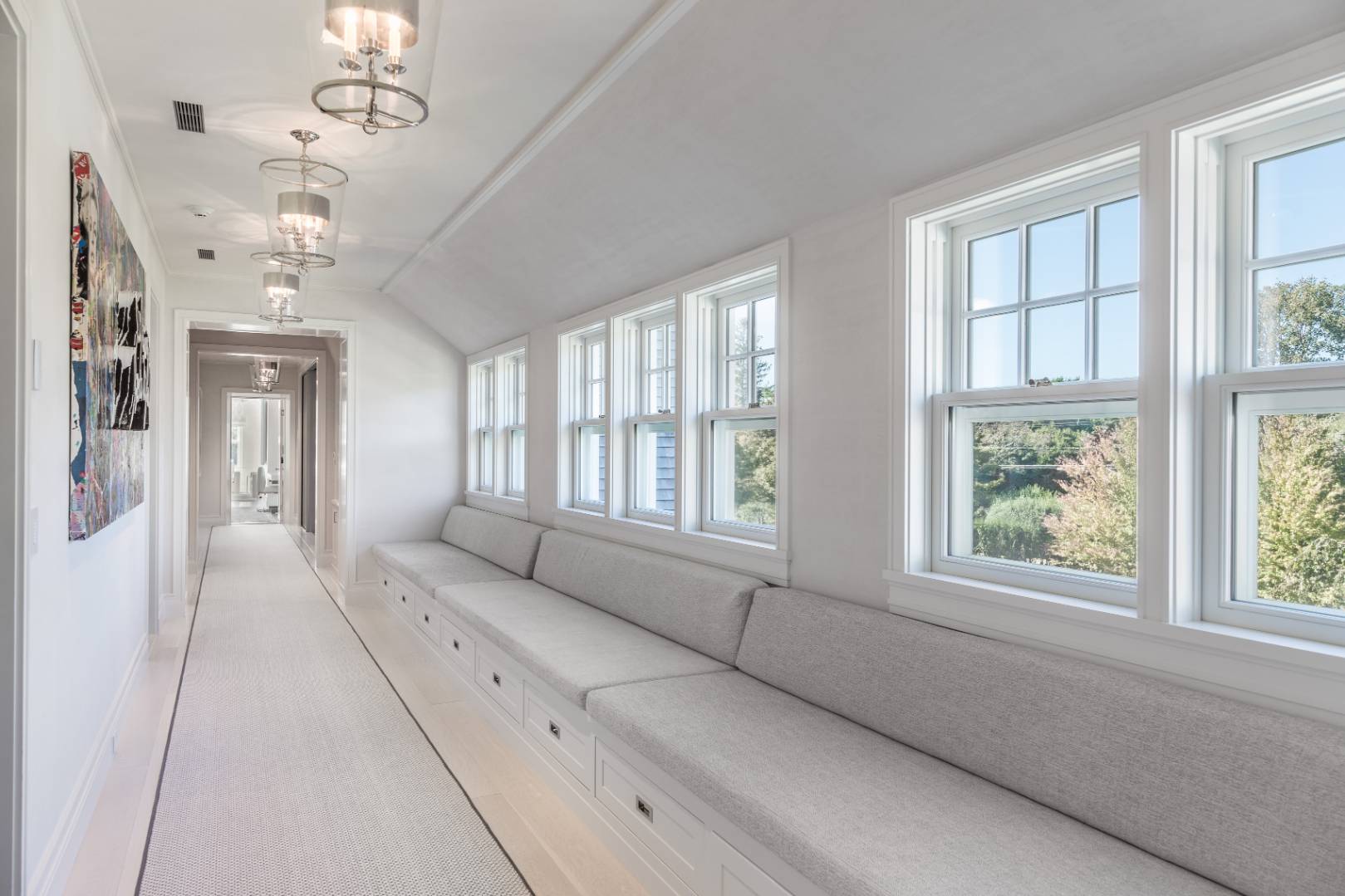 8 Hither Lane East Hampton, NY 11937 - Photo 22 of 38 a living room with furniture and a chandelier