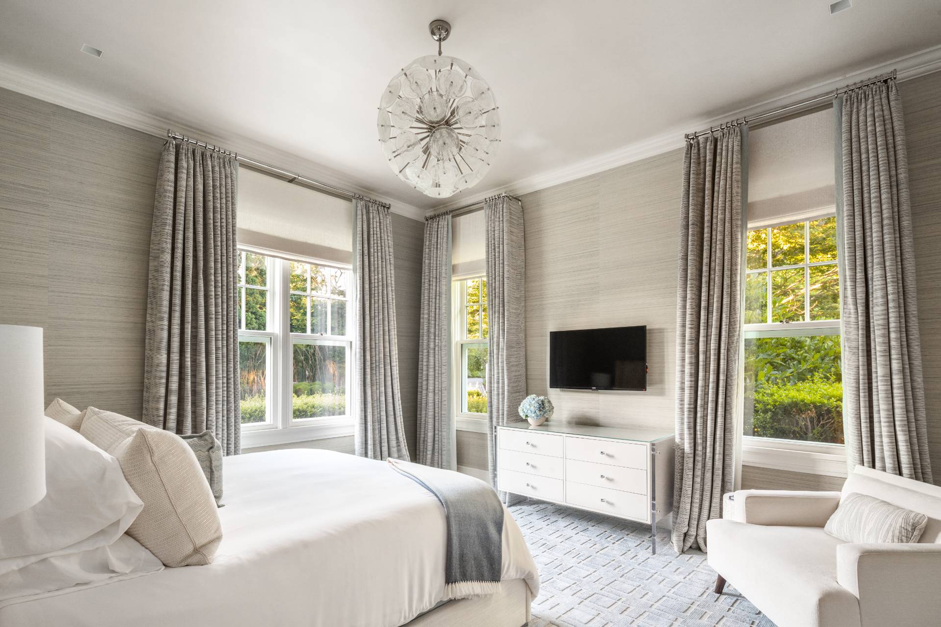 8 Hither Lane East Hampton, NY 11937 - Photo 23 of 38 a bedroom with a large bed and a flat tv screen