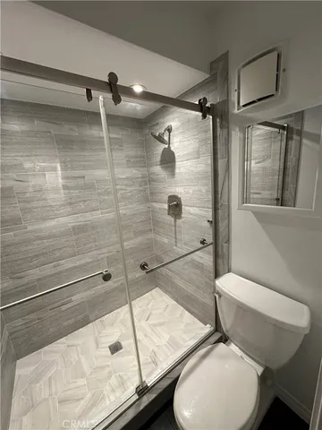 a bathroom with a toilet and a shower
