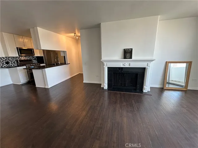 a view of kitchen with microwave stove and cabinets