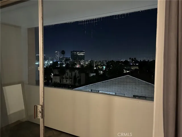 a bathroom with a granite countertop sink a mirror and toilet
