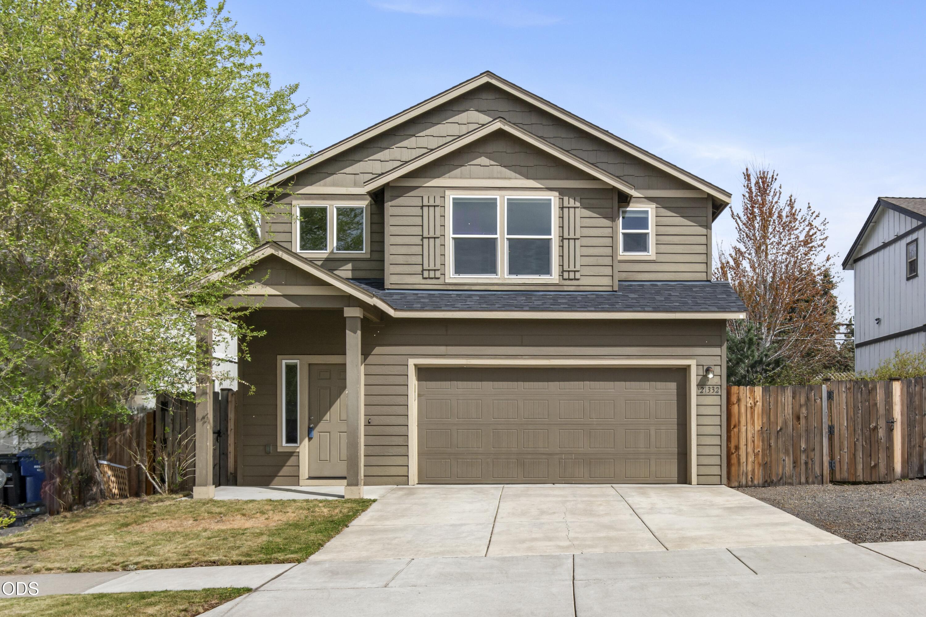 21332 Oconnor Way Bend, OR 97701 - Photo 1 of 33 a front view of a house with a yard and garage