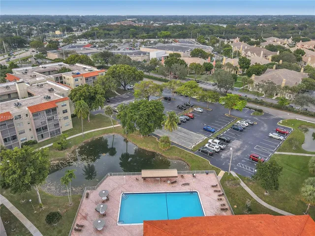 an aerial view of residential houses with outdoor space and parking