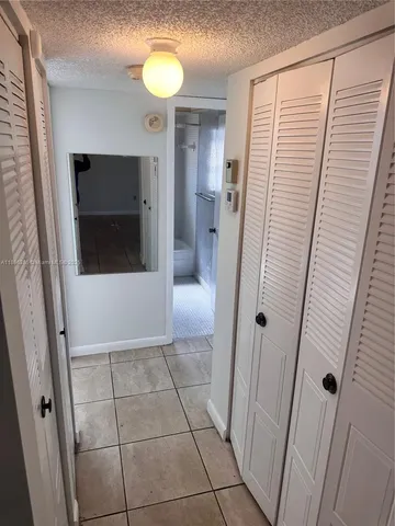a view of a hallway and a bathroom with a sink