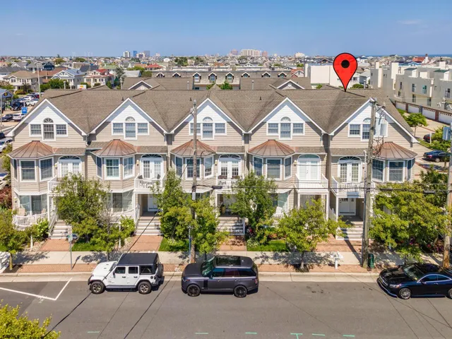 a view of multiple houses with a street