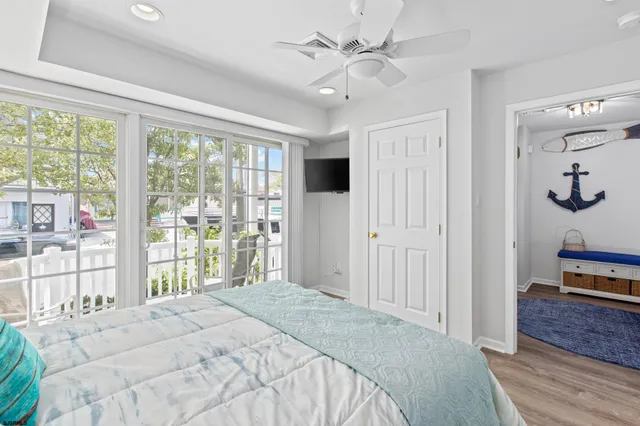 a bedroom with a bed and a large window