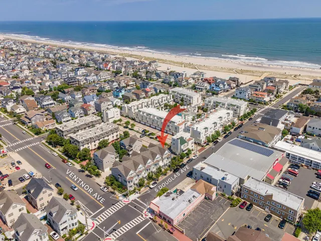 an aerial view of a city with ocean view