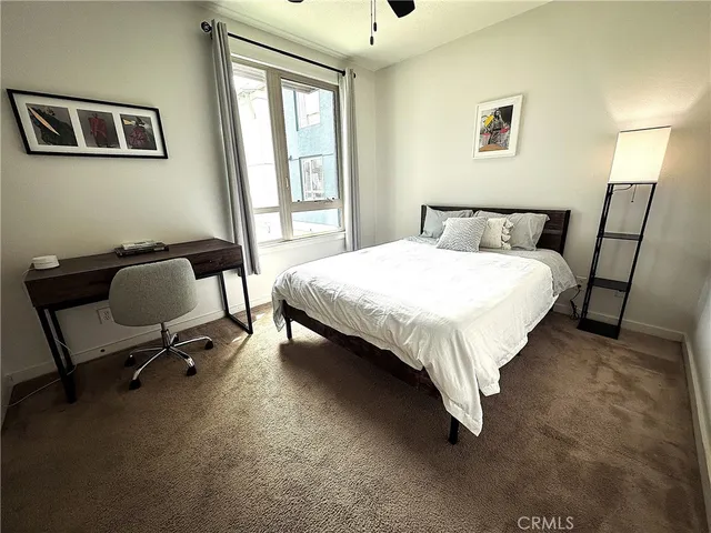 a bed sitting in a bedroom next to a window