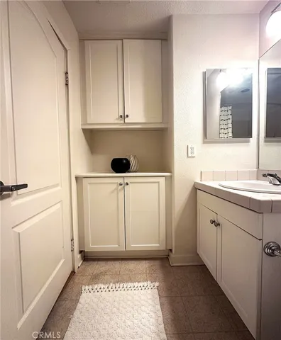 a bathroom with a sink a toilet and mirror