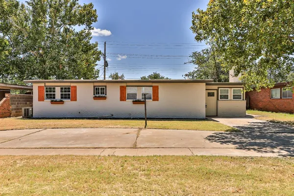 a front view of a house with a road