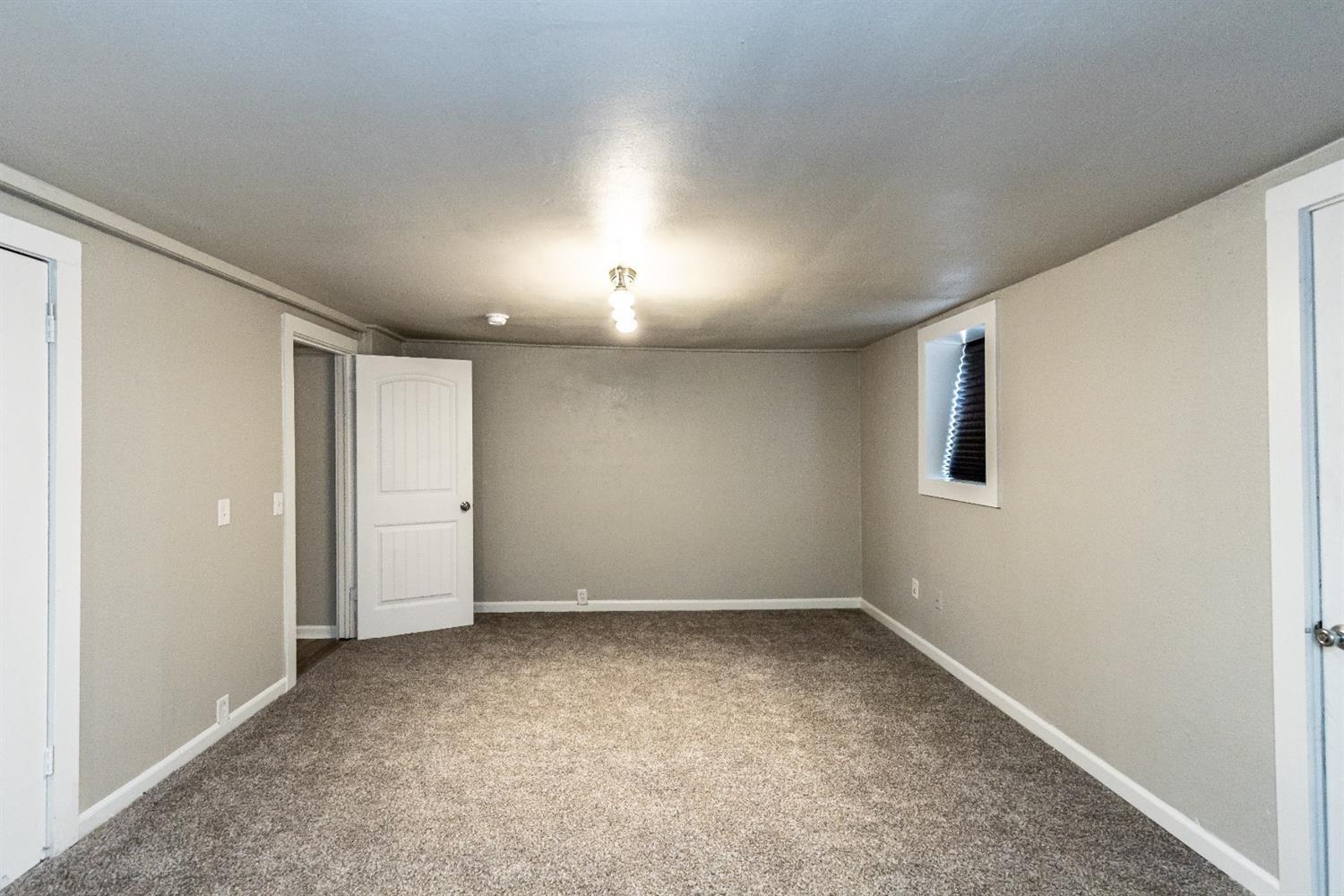 2723 66th Street Lubbock, TX 79413 - Photo 11 of 17 an empty room with a empty space and windows