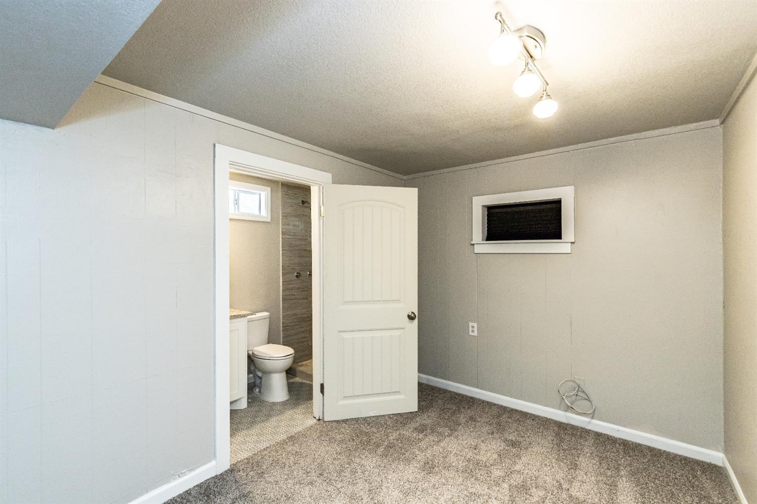 2723 66th Street Lubbock, TX 79413 - Photo 12 of 17 a view of a livingroom with wooden floor and a bathroom