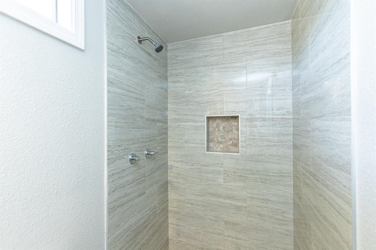 2723 66th Street Lubbock, TX 79413 - Photo 13 of 17 a bathroom with a shower
