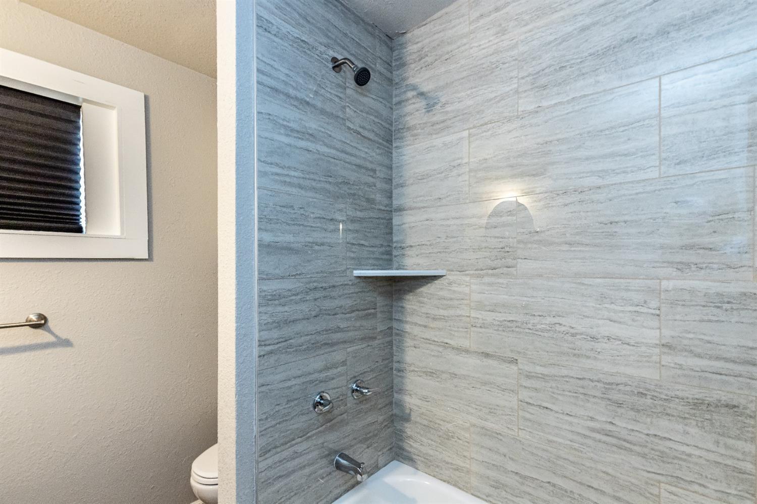 2723 66th Street Lubbock, TX 79413 - Photo 15 of 17 a bathroom with a shower