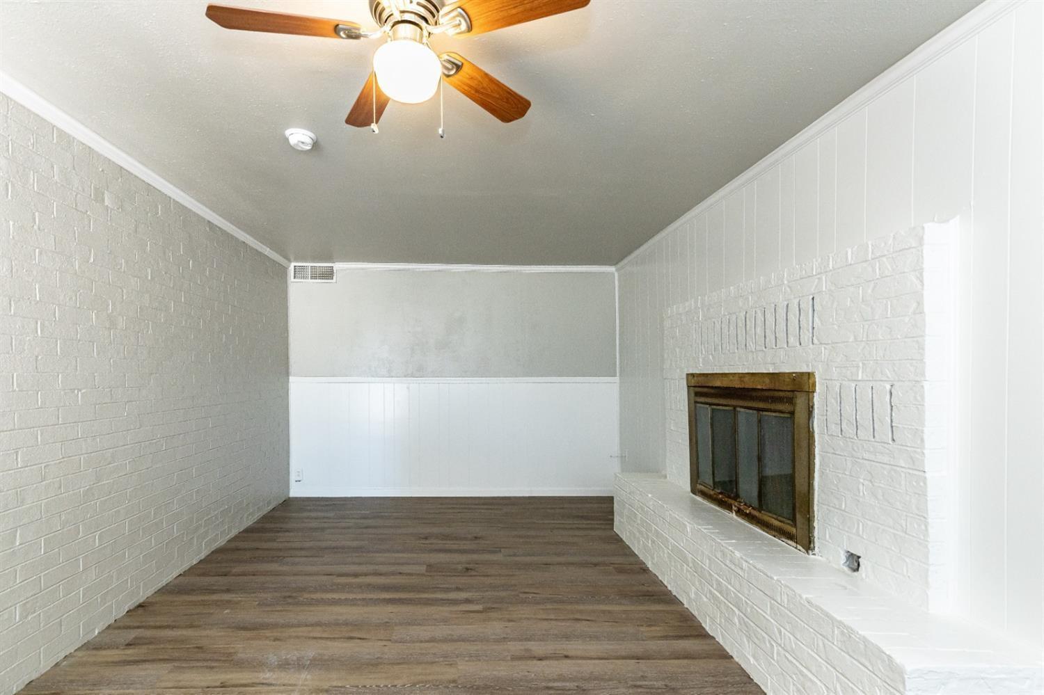 2723 66th Street Lubbock, TX 79413 - Photo 3 of 17 a view of empty room with wooden floor and fan