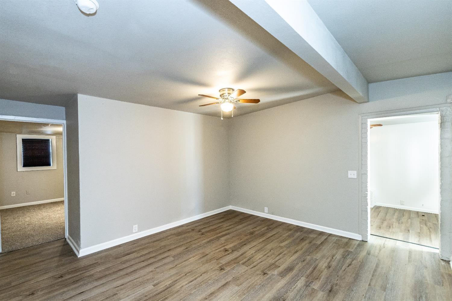 2723 66th Street Lubbock, TX 79413 - Photo 5 of 17 wooden floor in an empty room