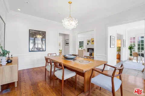 a large white kitchen with wooden floor