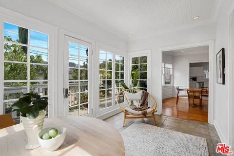a living room with furniture and floor to ceiling windows