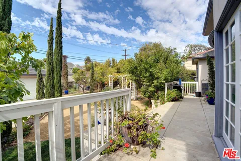 a view of a patio with table and chairs potted plants