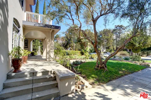 a view of a house with a yard and tree s
