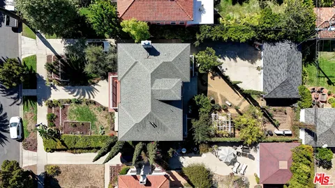 an aerial view of a house with a yard and potted plants