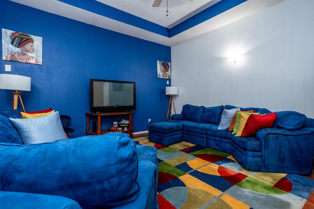928 Trinity Drive Lancaster, TX 75146 - Photo 19 of 31 a living room with furniture and a flat screen tv