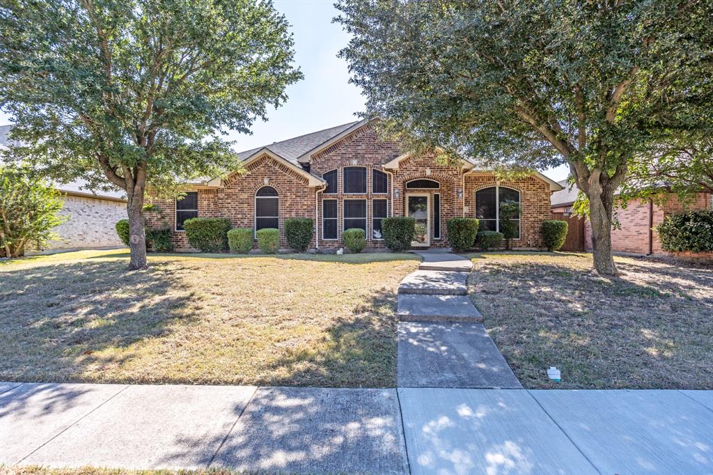 928 Trinity Drive Lancaster, TX 75146 - Photo 2 of 31 a front view of a house with a yard