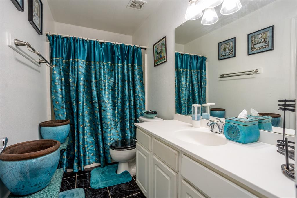 928 Trinity Drive Lancaster, TX 75146 - Photo 21 of 31 a bathroom with a sink and a mirror