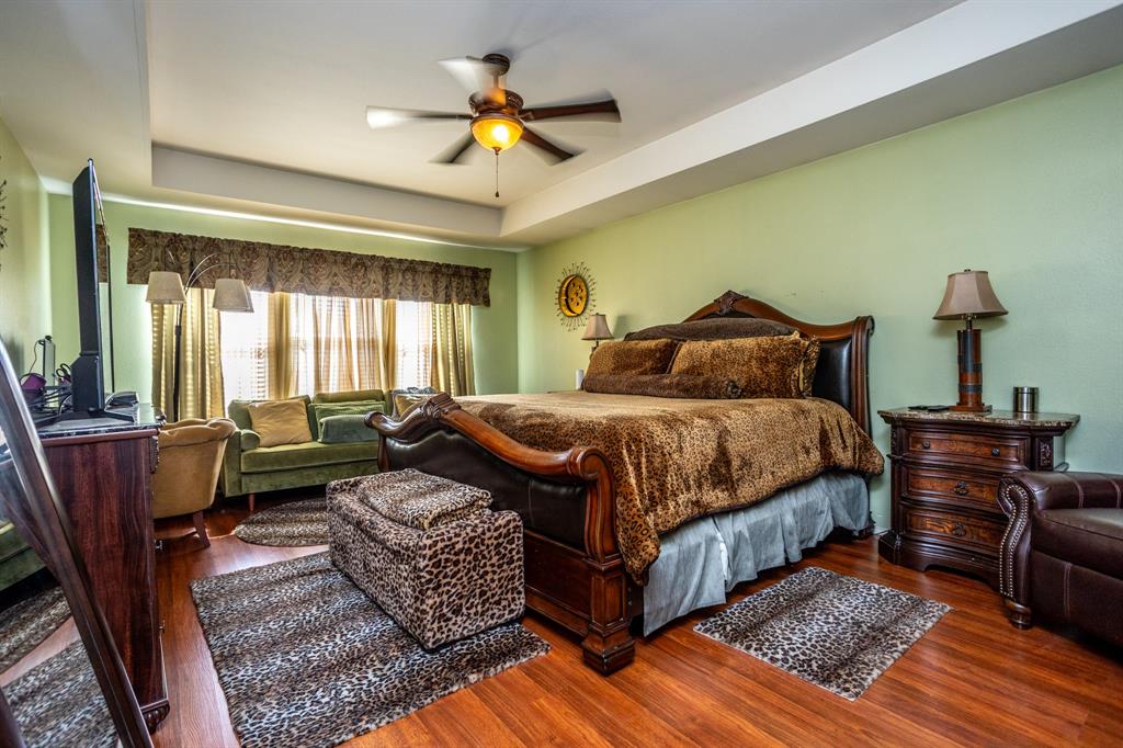 928 Trinity Drive Lancaster, TX 75146 - Photo 24 of 31 a bedroom with a bed and wooden floor