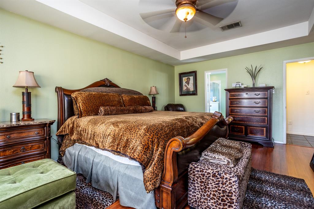 928 Trinity Drive Lancaster, TX 75146 - Photo 25 of 31 a bedroom with a bed and a chandelier
