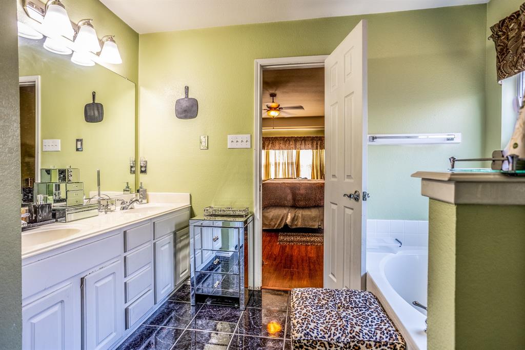 928 Trinity Drive Lancaster, TX 75146 - Photo 27 of 31 a bathroom with a double vanity sink toilet and shower