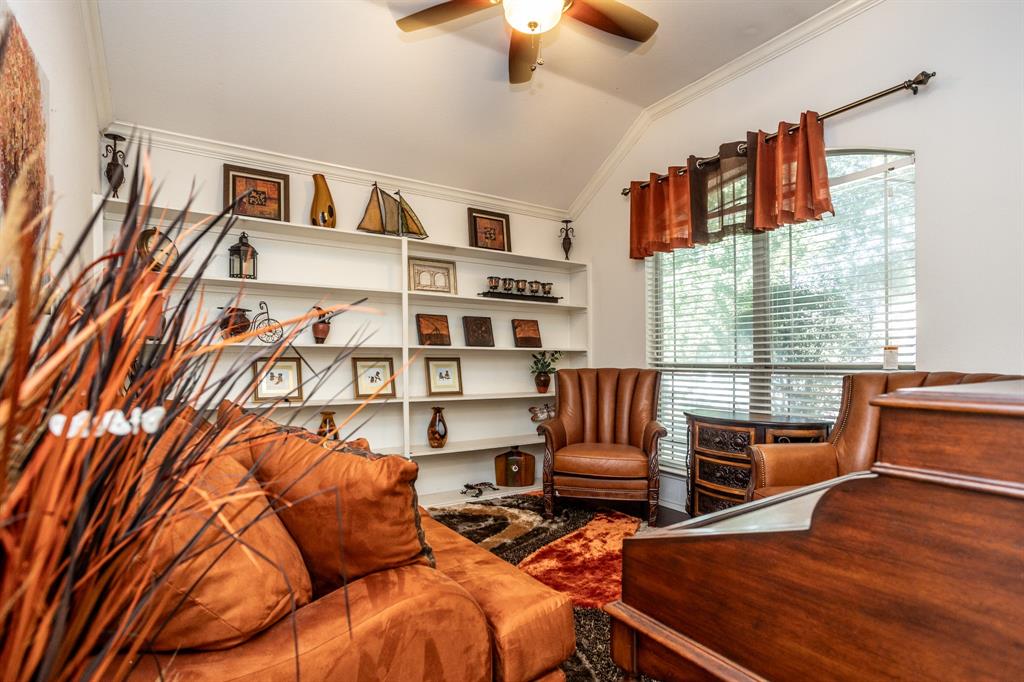 928 Trinity Drive Lancaster, TX 75146 - Photo 5 of 31 a bedroom with furniture and a book shelf