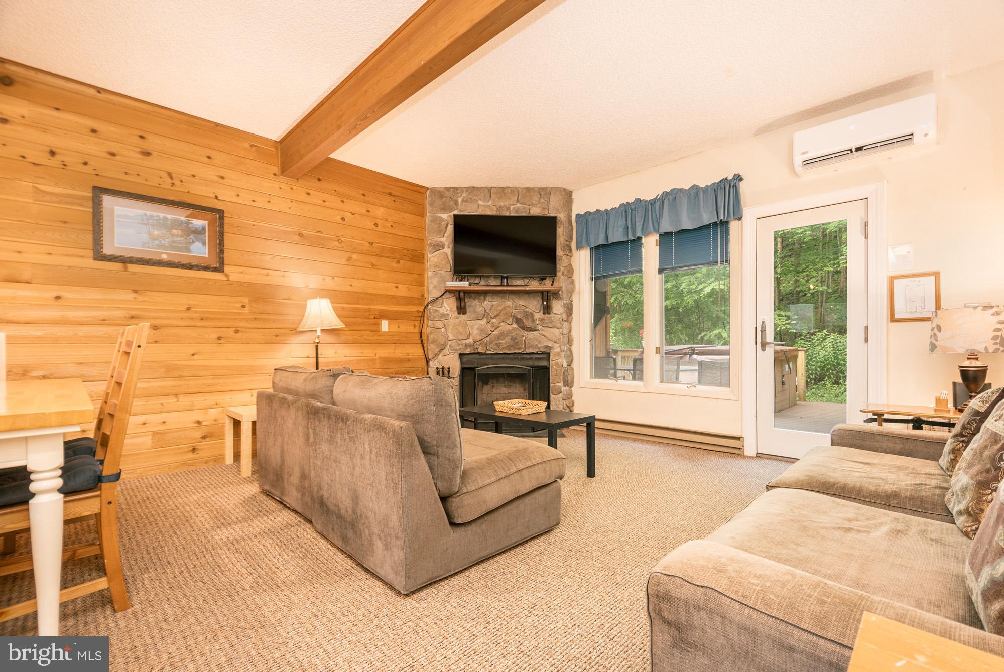 18 Winding Way, Unit 18D McHenry, MD 21541 - Photo 16 of 48 a living room with furniture a fireplace and a flat screen tv