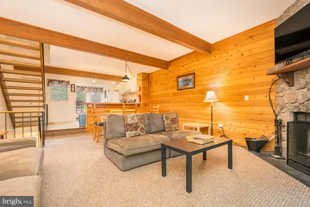 a living room with patio furniture and a flat screen tv