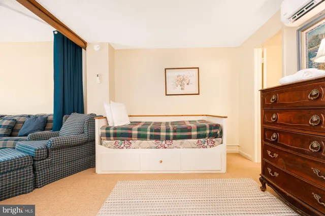 a living room with furniture and a large mirror