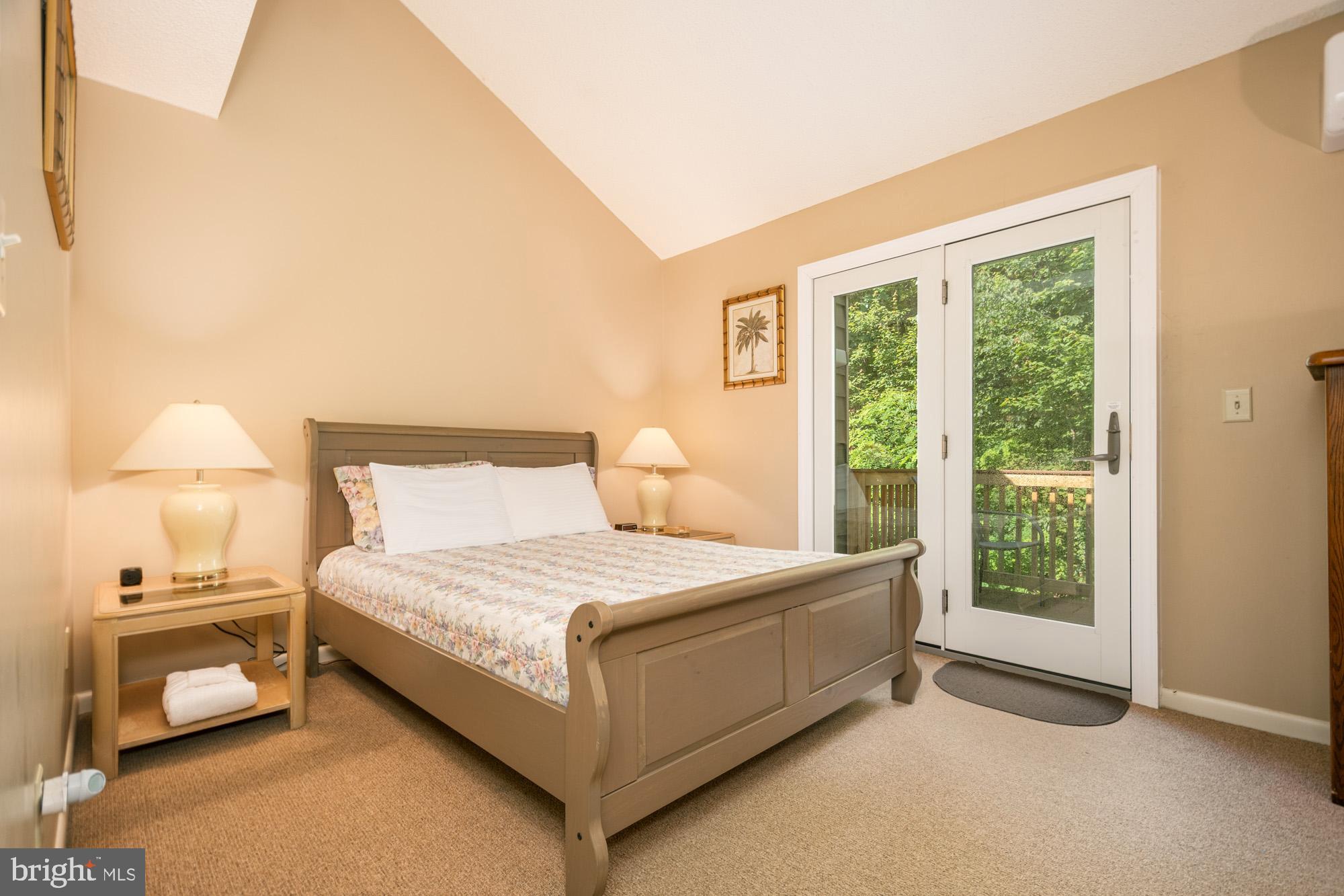 18 Winding Way, Unit 18D McHenry, MD 21541 - Photo 35 of 48 a bedroom with a bed and a night stand