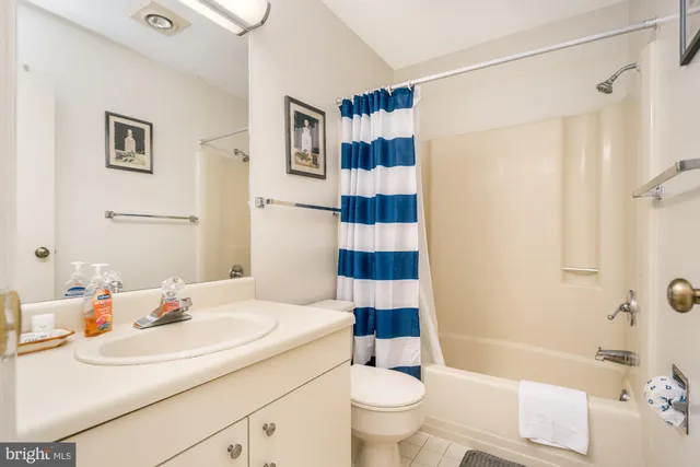 a bathroom with a sink mirror vanity and toilet