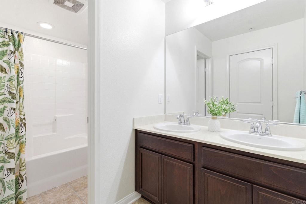 1508 Carpinteria Street Chula Vista, CA 91913 - Photo 22 of 39 a bathroom with a sink and a mirror