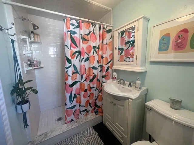 a bathroom with a sink and a shower curtain