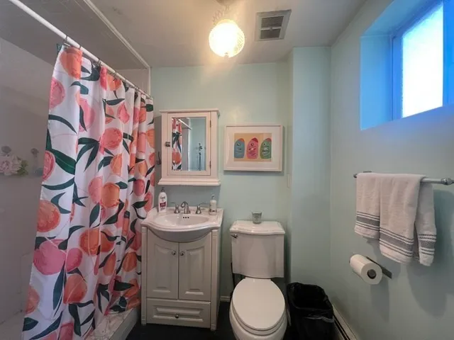 a white toilet sitting next to a bathroom sink