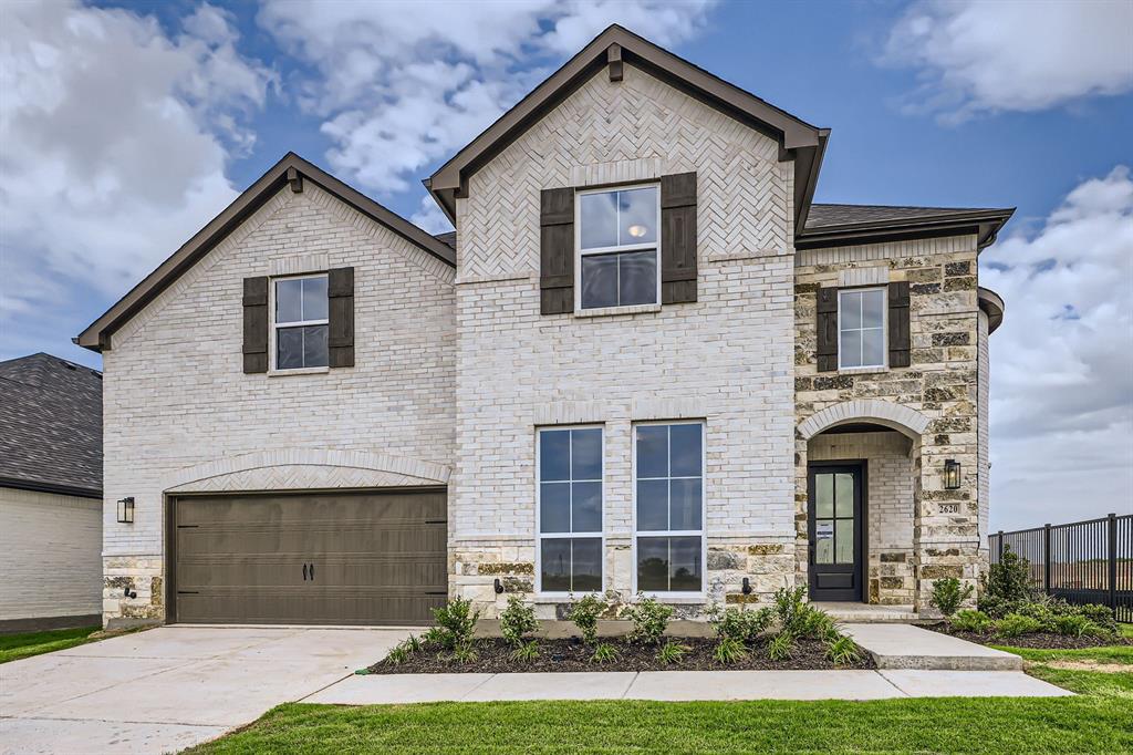2620 Cedar Rdg Road Celina, TX 75009 - Photo 1 of 27 French country home featuring an attached garage, stone siding, and brick siding